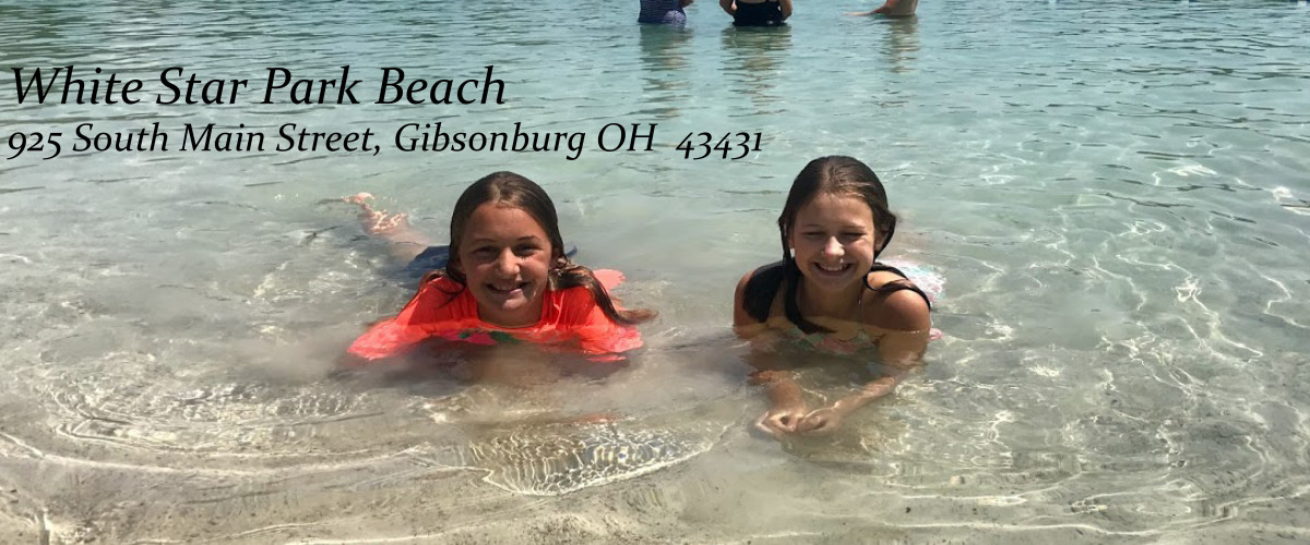 Two kids laying in the water at the beach. White Star Beach - 925 South Main Street, Gibsonburg, OH 43431